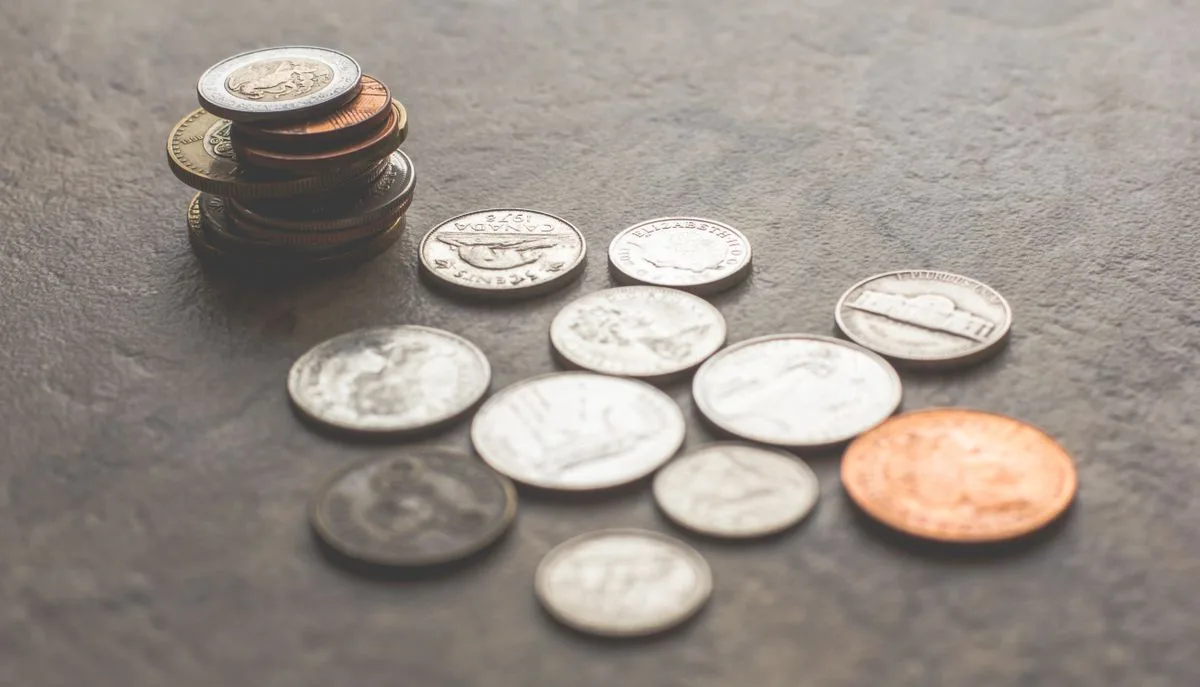 A large pile of coins representing the wave of 2021 meme coin launches